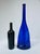 Tall cobalt blue glass vase with an unusual flattened bottle form and sweeping molded fold across the lower body. The...