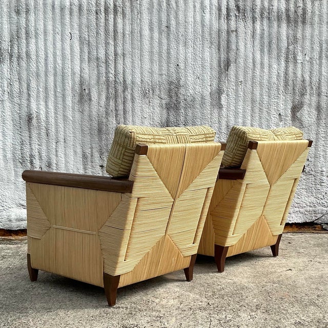 Elevate your space with this pair of Vintage Coastal Donghia “Merbau” Woven Rattan Lounge Chairs. Expertly crafted with...