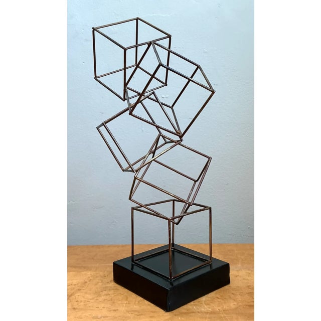 Showcasing dynamic modernist geometry and an open wireframe structure, this vintage mid-century sculpture features a...