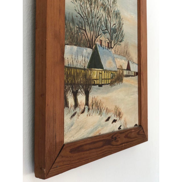 A vintage original oil painting of a snowy Scandinavian cottage, dating from 1960. The scene shows a yellow house with...