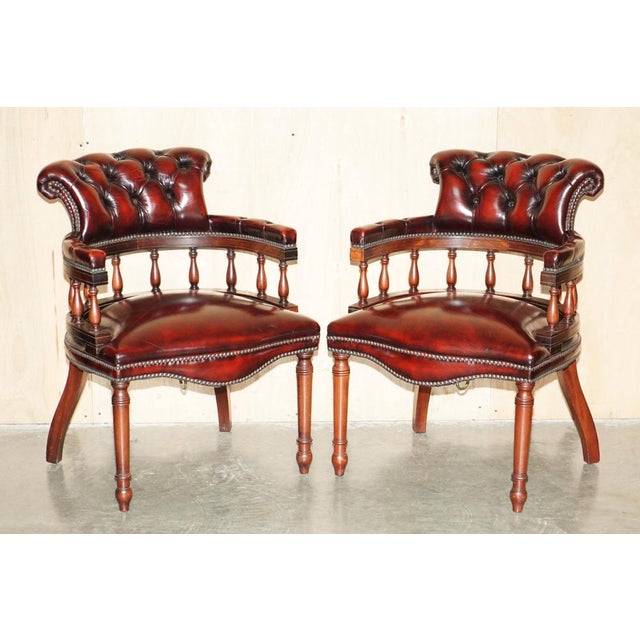 Stunning pair of hand made in England, Oxblood Leather, Chesterfield captains armchairs with the very unique solid brass...