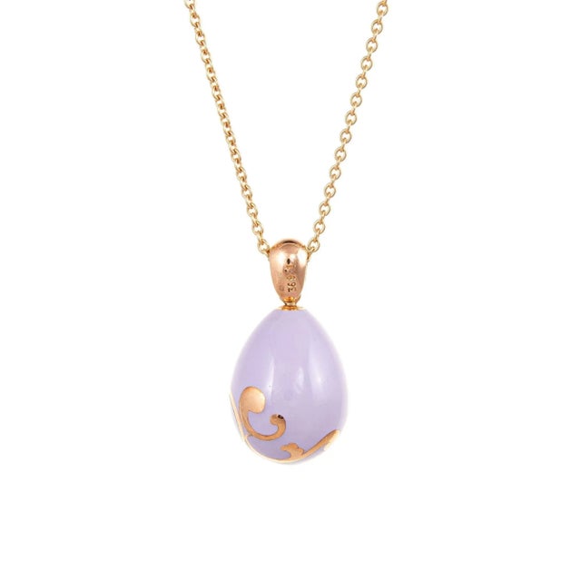Elegant and finely detailed estate Faberge lilac egg pendant & necklace crafted in 18 karat rose gold. The egg features...