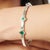 Elevate your jewelry collection with this elegant Green Onyx bangle bracelet crafted in polished sterling silver....