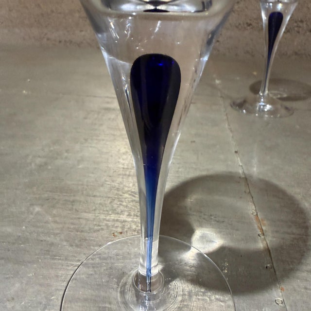For your consideration, pair of Orrefors Intermezzo Blue wine glass featuring a distinct dark blue drop trapped inside the...