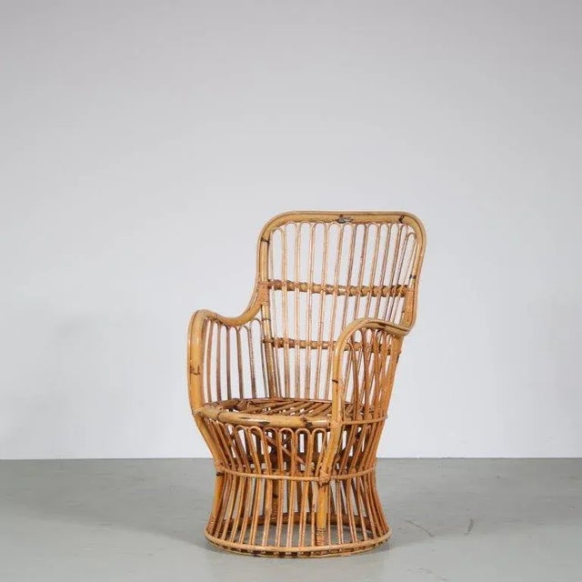 This charming small armchair dates back to the 1950s and features a rattan frame, creating a light and airy feel. The...