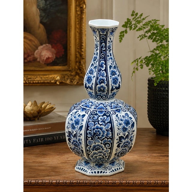 A handsome blue and white Delft-style ceramic vase made exclusively for Baker Knapp & Tubbs and produced in Holland. This...