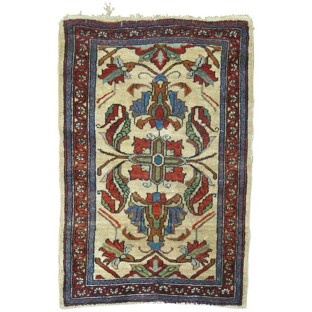 An early 20th century finely decorative Persian rug. Ivory bone field, accents in red rust and green, circa 1910,...