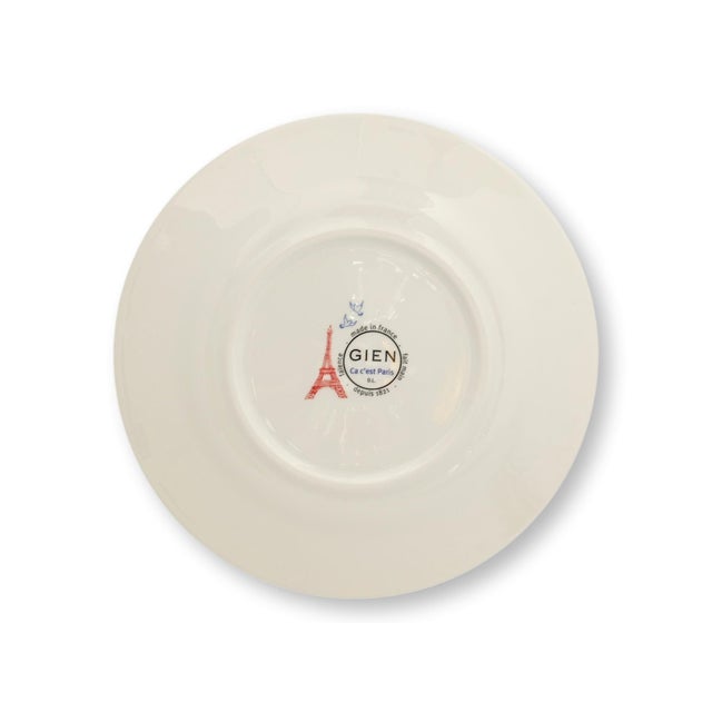 Set of four French Gien dessert plates in the collectible "Ca c’est Paris" pattern. Each plate features whimsical black...