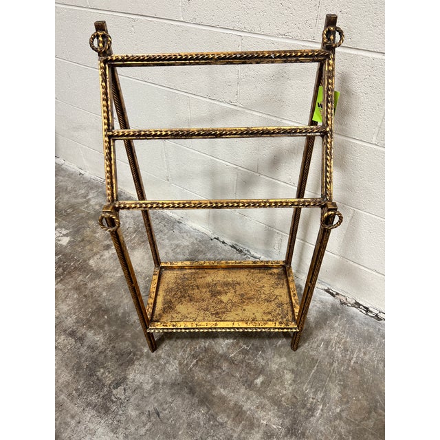 This is a perfect little glammy freestanding towel rack. Heavy iron gilded in gold.Three bars for hanging towels and a...