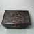 Solid hardwood storage chest heavily carved with dynamic twin dragons chasing flaming pearls amid swirling cloud patterns,...