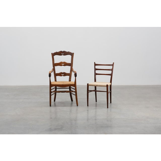 A charming French Provincial ladder‑back armchair from the 19th century, crafted in solid wood with a warm, hand‑polished...