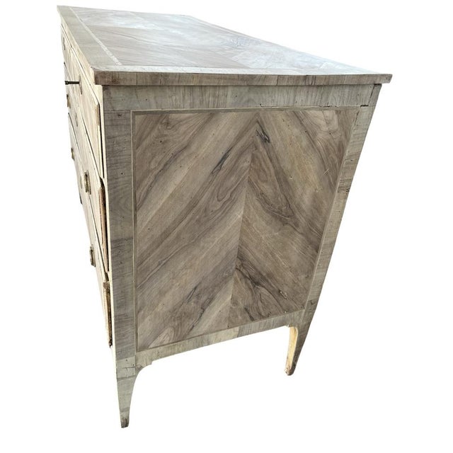 Neoclassical commode hand-made in Italy in the late 1700s using oak and decorated with walnut veneer. The chest of drawers...