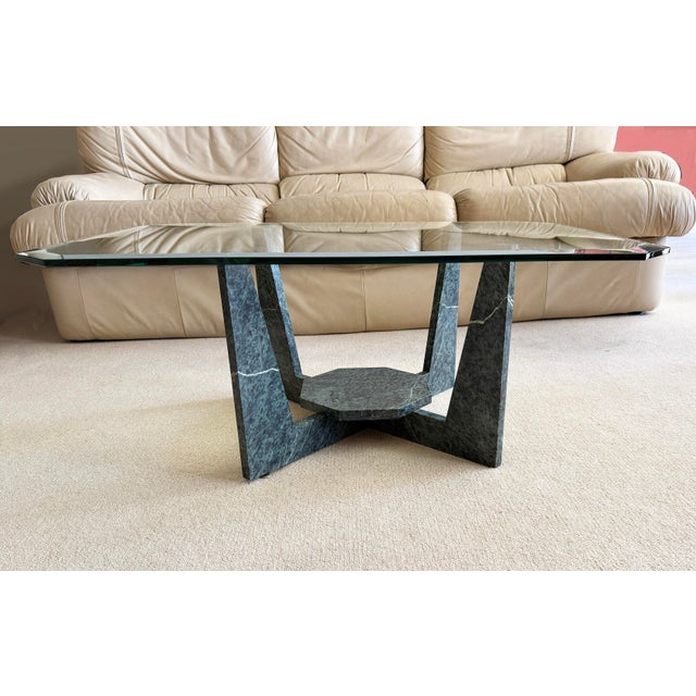 Check out this unique 1980s Postmodern (Art Deco Revival) style glass-top cocktail table with a geometric sculptural base....