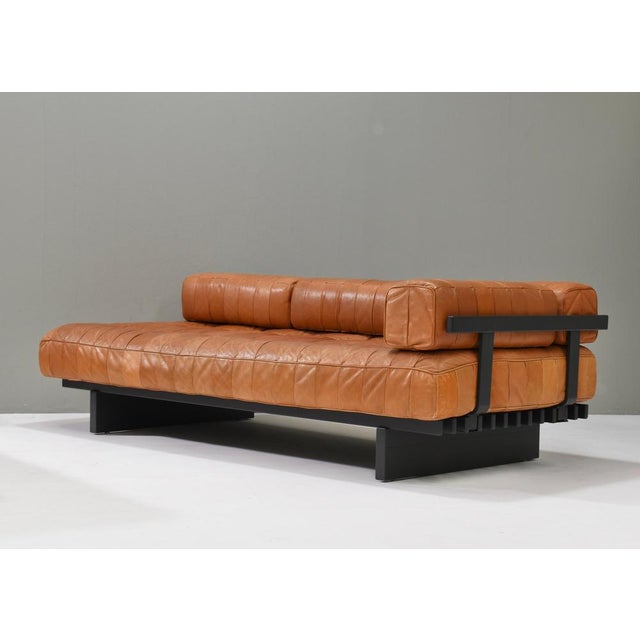 Introducing this gorgeous center piece Cognac Brown DS80 patchwork daybed sofas by de Sede. The arm and back supports made...