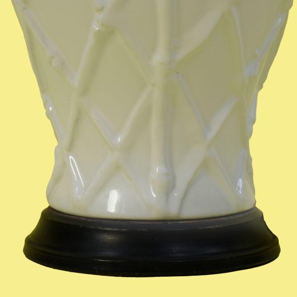 A single white table lamp with a faux-bamboo base, bringing fresh coastal character to a bedside or console. The crisp...
