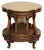 French style dark tone wooden side table with ornate carved details, a round top, and metal grid details on the side. Age...