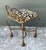 This whimsical Hollywood Regency vanity stool is a masterclass in playful elegance, blending sculptural form with a bold...