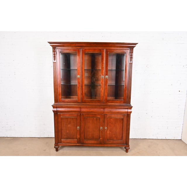 A gorgeous French Provincial or French Regency Louis XVI style lighted display cabinet or breakfront bookcase By Ethan...