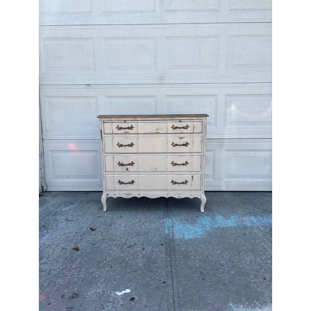 We have a beautiful vintage French Provincial dresser for sale, featuring classic Louis XV styling with a softly curved...