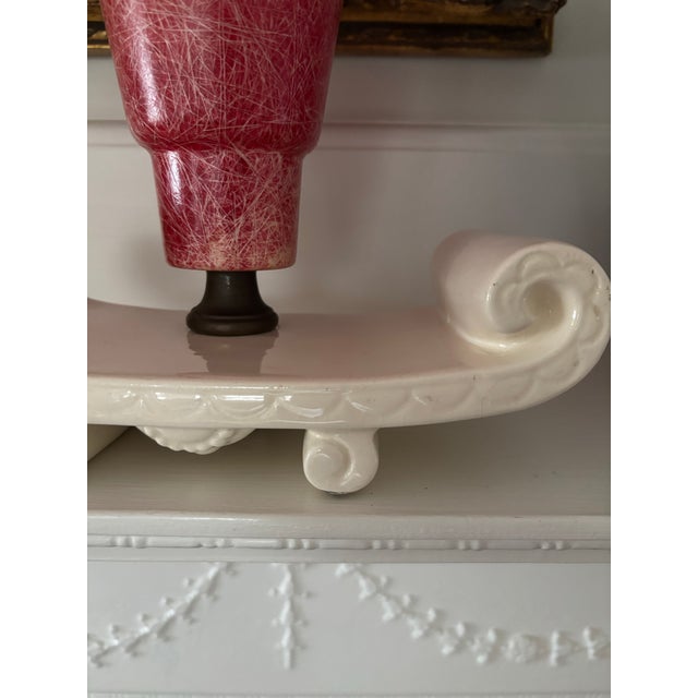 This nostalgic “magic carpet” tv lamp features a cream colored, sculptural ceramic base, inspired by the flowing shape of...