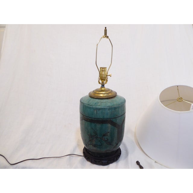 This 19th Century Chinese ceramic vase is made into a lamp with updated wiring, wooden base and 18"Diameter paper shade....