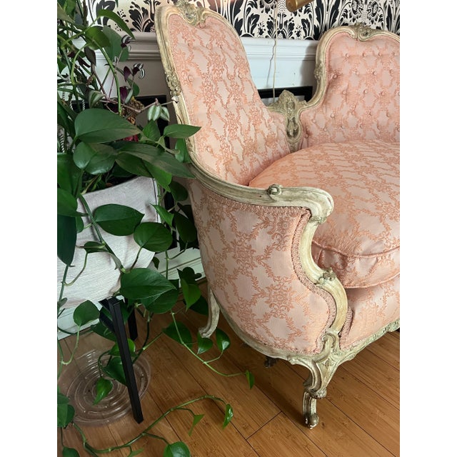 Up for consideration is a beautiful vintage French pink cushioned settee with a white wooden frame. This is a gorgeous...