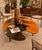 The generously sized, organically shaped tabletop showcases a dynamic composition of sweeping curves, angular forms, and...