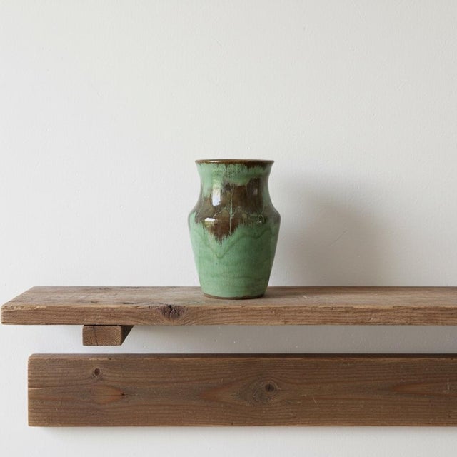 1970's studio pottery handmade ceramic vase. It features a fluted neck, a wide shoulder, and a tapered base, covered in a...