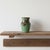 1970's studio pottery handmade ceramic vase. It features a fluted neck, a wide shoulder, and a tapered base, covered in a...