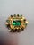 A vivid 1960s DeLizza & Elster brooch designed in a rich emerald‑green palette. The rectangular faceted center stone is...