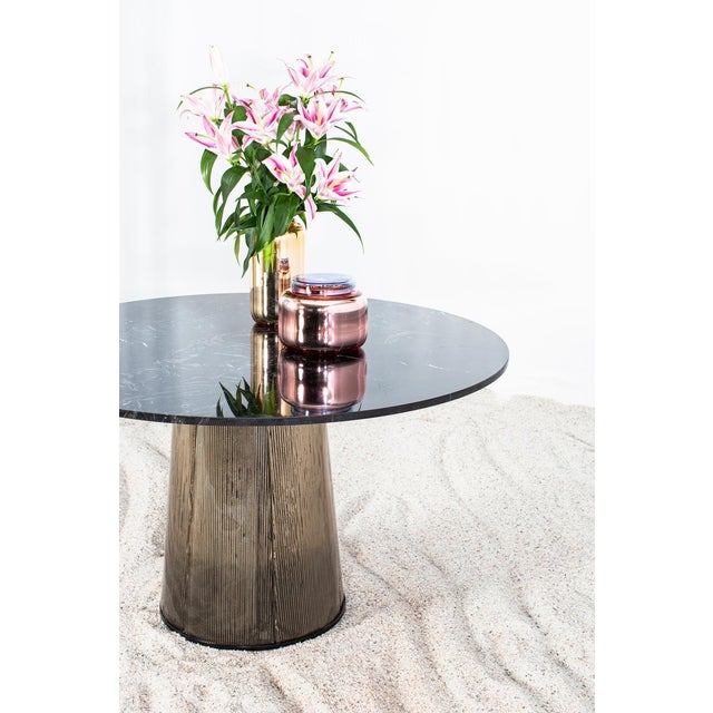 Two kinds of material united in one table. Sebastian Herkner’s fine, characteristically bent with its rippled visual has...