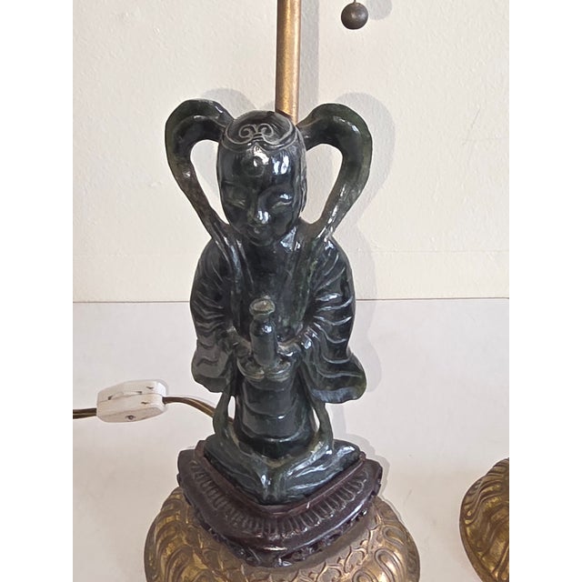 Pair of finely carved Dark Green Jade diety figures mounted on fine dark wood bases and then mounted on Gilt brass bases....