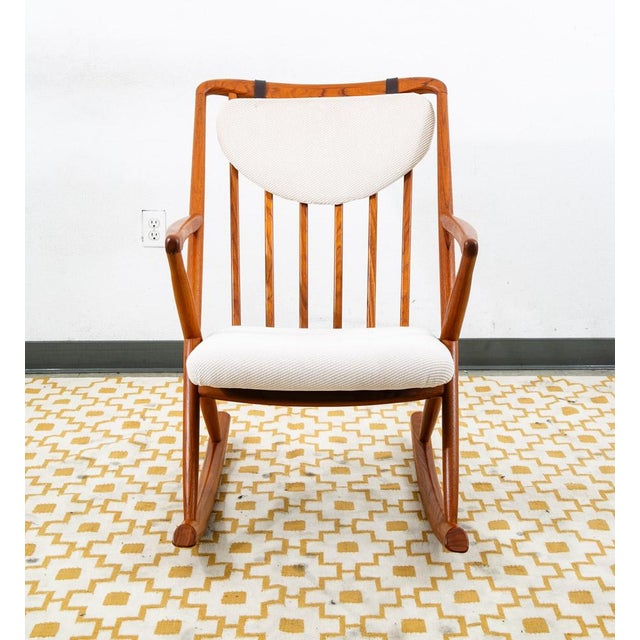 Beautiful solid teak rocking armchair designed by Benny Linden, An iconic and well known maker of Scandinavian furniture....