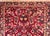 A classic early 20th century Persian Sarouk rug with an all-over mirrored pattern containing myriad floral clusters,...