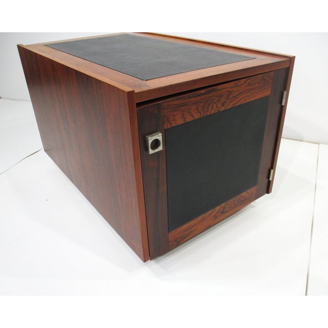 A luxurious rich and dark Brazilian rosewood cubed side table with a door having a chrome pull and storage inside . The...