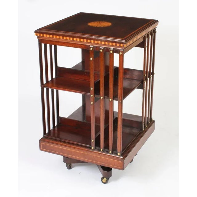 This an exquisite antique revolving bookcase attributed to the renowned victorian retailer and manufacturer maple & co.,...