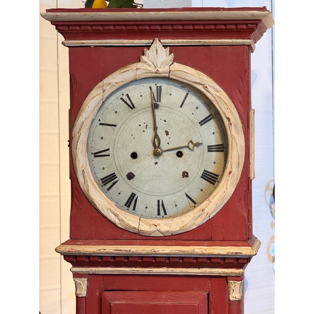 A 19th century Swedish tall clock with a painted case, the hood fitted with a glazed circular dial door and Roman numeral...