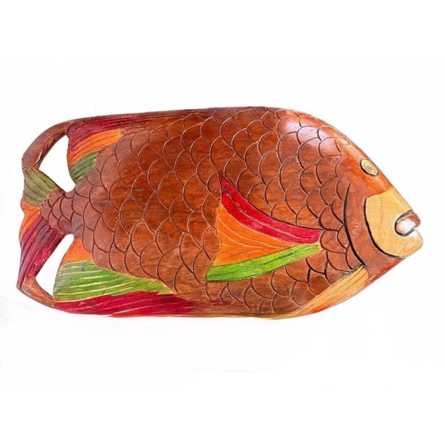 Bring a touch of coastal charm to your home with this striking, hand-crafted wooden fish platter. This versatile piece...