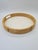 A stylish, round tray made of bent rattan (bamboo) with a wooden panel insert. Its classic form and natural material evoke...
