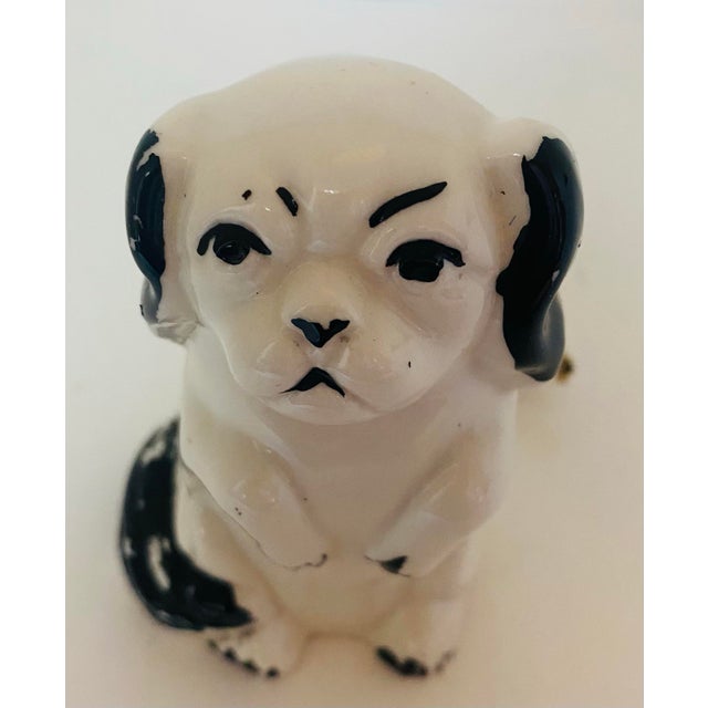 An early 20th century (probably 1930s) white and black ceramic 3-way electric plug in the shape of a begging puppy. Why...