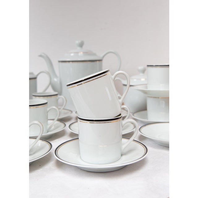 All pieces are signed. The design corresponds to the CRISTAL or PALMYRE model with navy blue and fine gold trim. The set...