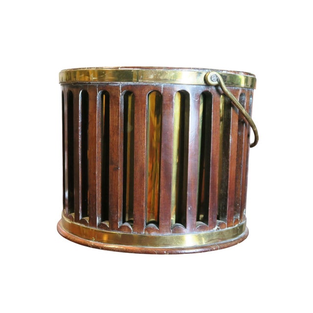 Of pierced ribbed form with a brass swing handle with a later brass liner height: 8 1/2 inches diameter 11 inches.
