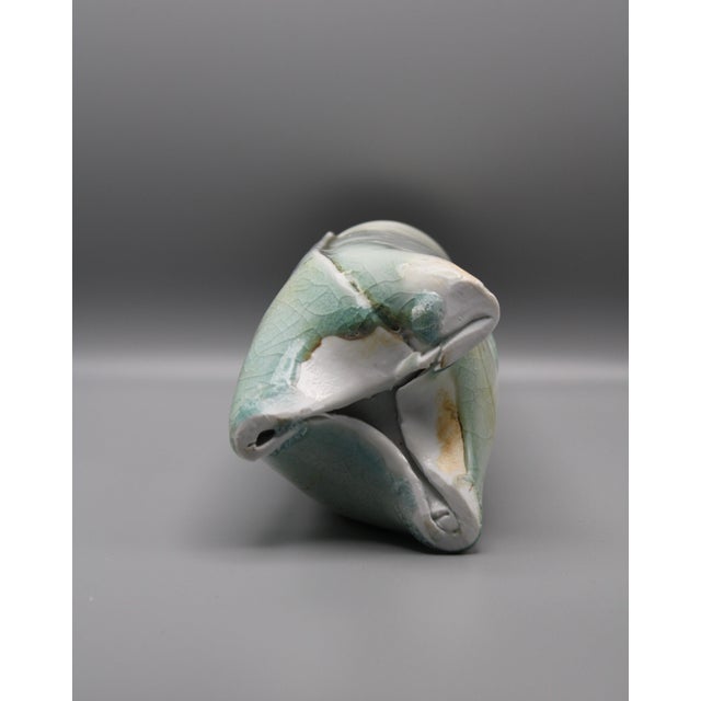 Hand formed pottery vase. made to look like a rolled paper tube with three twisted feet to base, a perfect addition for...