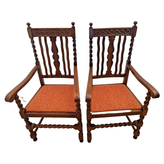 Elevate your interior with this handsome pair of vintage Jacobean Revival armchairs. Expertly crafted from rich, dark oak,...