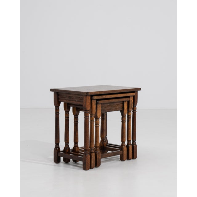 A set of three oak nesting tables from France, dating to circa 1970, designed with a compact and functional structure....