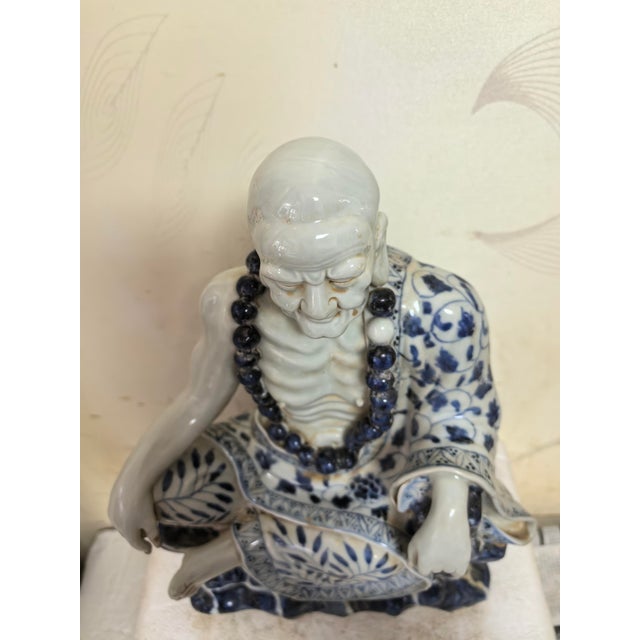 W-24cm,H-32cm This hand-carved blue and white porcelain statue depicts The Eighteen Arhats, a traditional Chinese Buddhist...