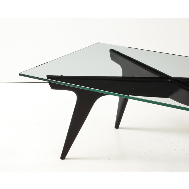 1960's modernist ebonized dark brown mahogany base with glass top italian coffee table in the style of Gio Ponti, fully...