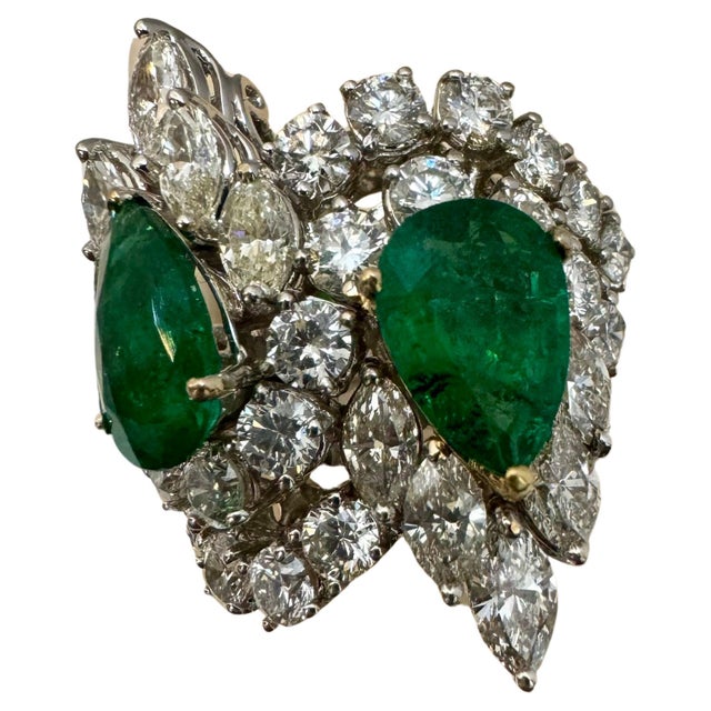 Introducing our exquisite 18 Karat White Gold Ring featuring two stunning Pear shape natural Zambian Emerald and 8.75...