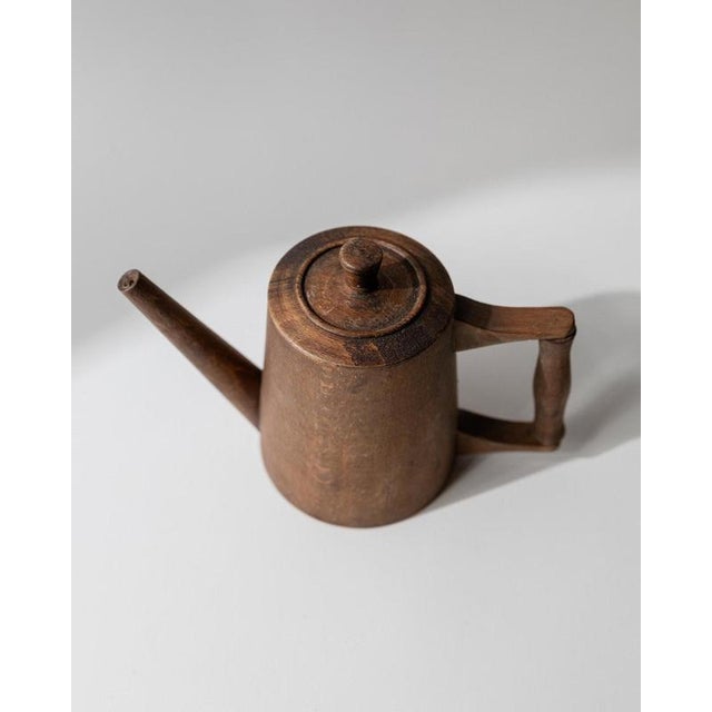 This vintage wooden pitcher from the 1960s is a beautifully hand-carved example of rustic folk art craftsmanship. Its...