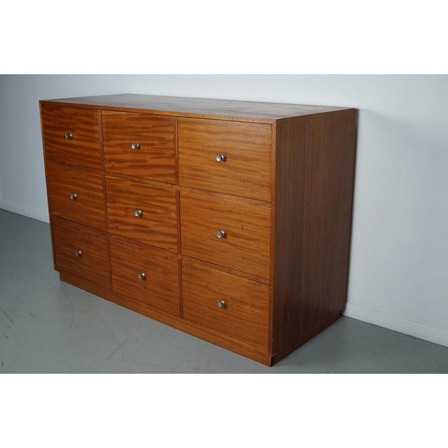 This vintage cabinet was made around the 1960 is in the Netherlands. It features 9 large sized practical drawers. It...